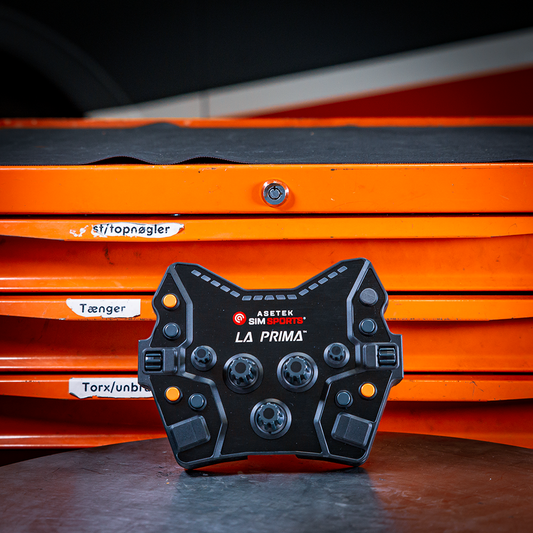 Asetek Simsports La Prima Button Box on a workbench with orange tool drawers in the background.